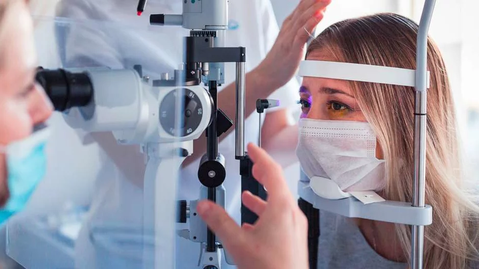Photo of patient in performing eye test with Ophthalmologist 